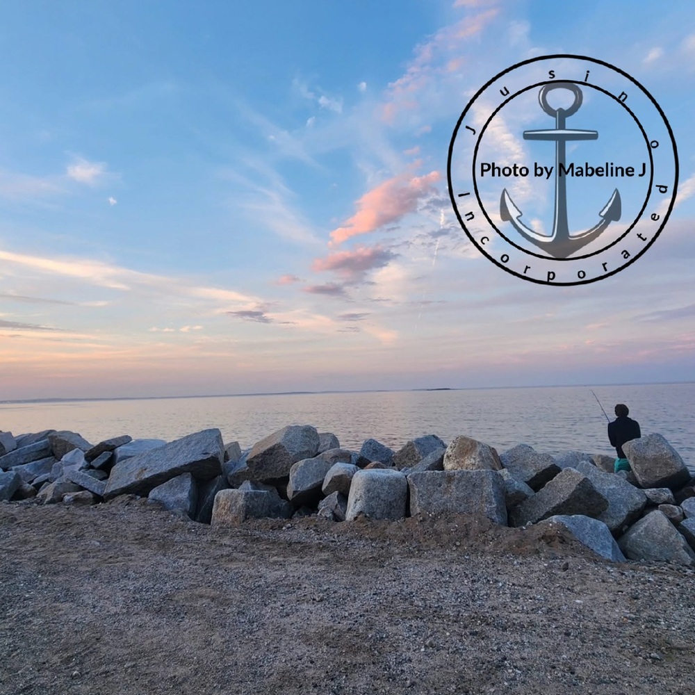 Scenic Ocean View with Rocks and Fisherman